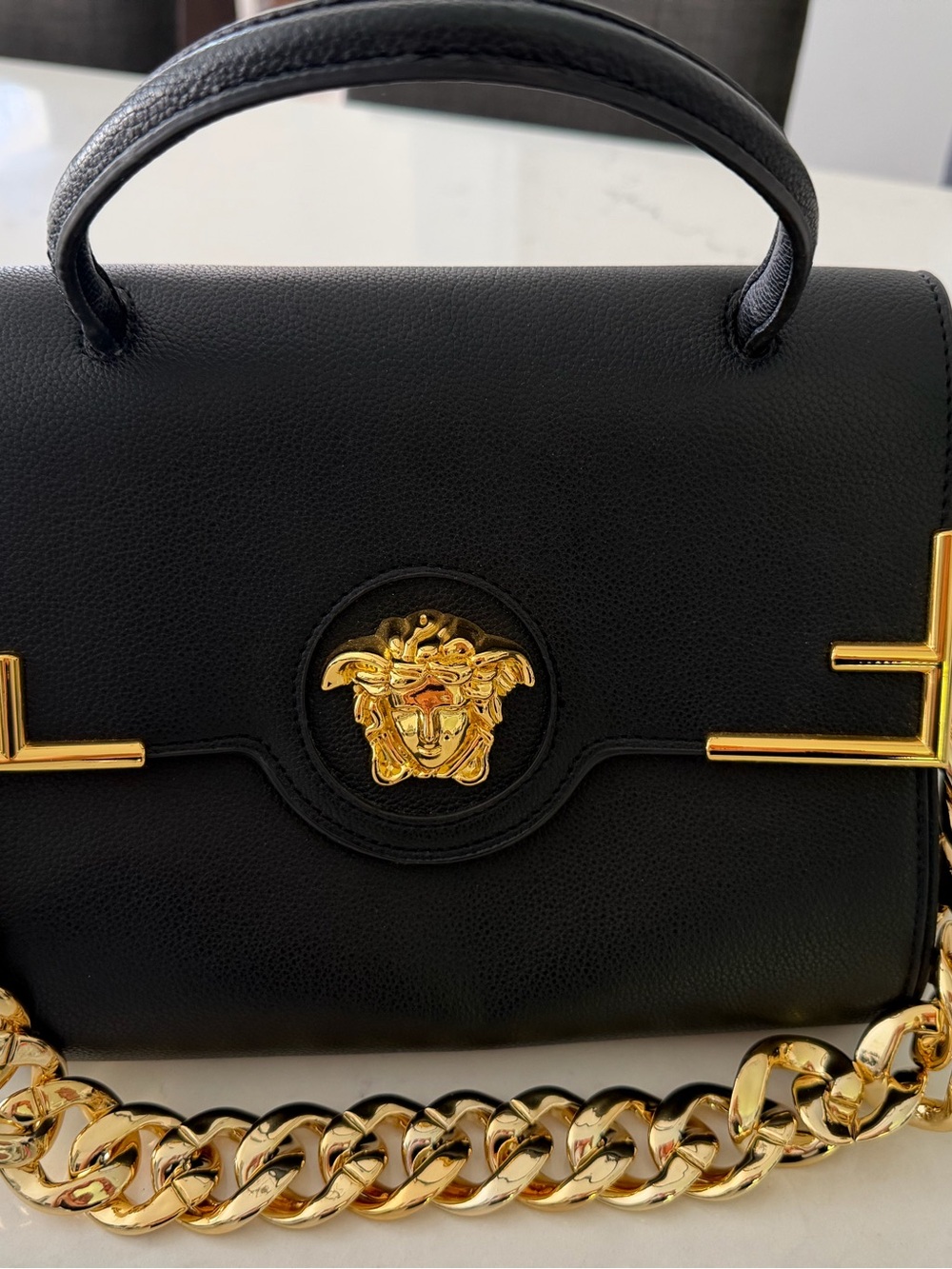Black Leather Shoulder Bag with Gold Medallion and Chain